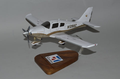 Model airplane on a wooden display base with a visible brand logo against a gray background